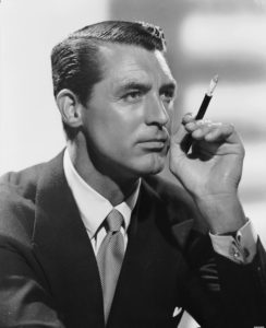 cary grant looking suave holding a cigarette